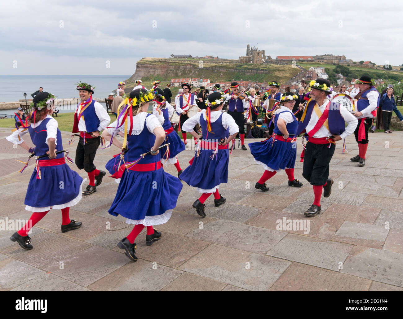 Morris dancers perform at Whitby with the Abbey in the background, Yorkshire, England, UK Stock Photo