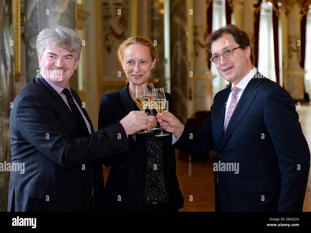 The new director of the Semperoper Serge Dorny (R) clicks glasses with Sabine von Schorlemer, minister of art (independent) and the manager Wolfgang Rothe in Dresden, Germany, 17 September 2013. Photo: Matthias Creutziger   (ATTENTION: Editorial use only by Matthias Creutziger) Stock Photo