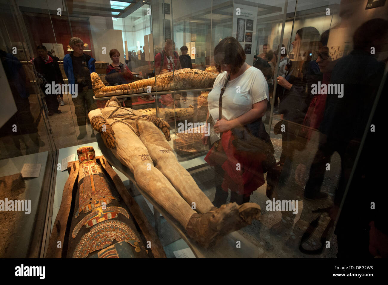 British Museum, London, England. 9-2013 Visitors enjoy the displays of Mummies in the Egyptian Galleries. Stock Photo