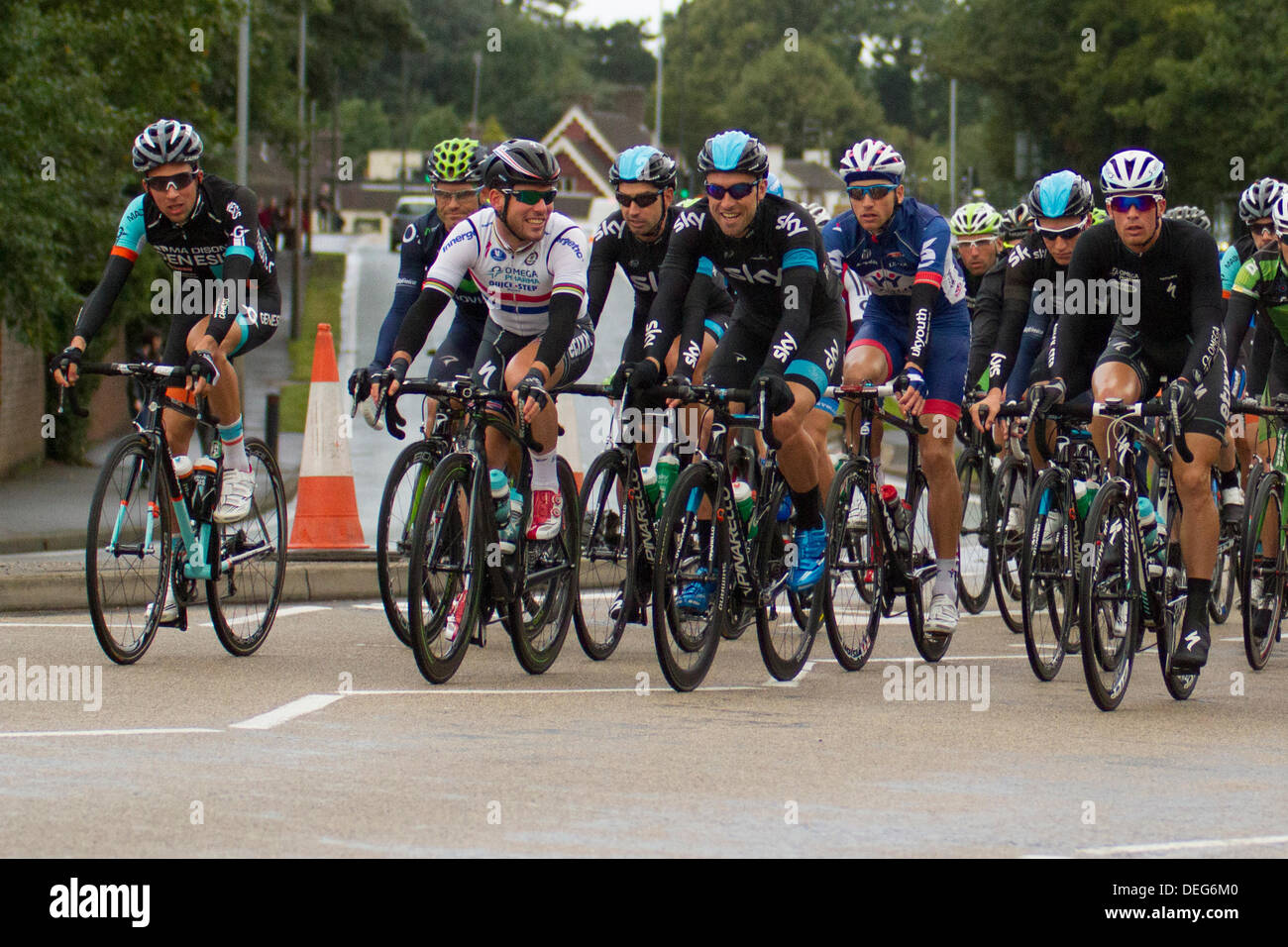 Stoke on Trent, Staffordshire, UK. 18th Sep, 2013. Mark Cavendish of Omega Pharma Quick-step shares a joke with Team Sky as they pass through the Trentham area of Stoke on Trent, Staffordshire on stage 4 of the Tour of Britain. Credit:  Alex Williams/Alamy Live News Stock Photo