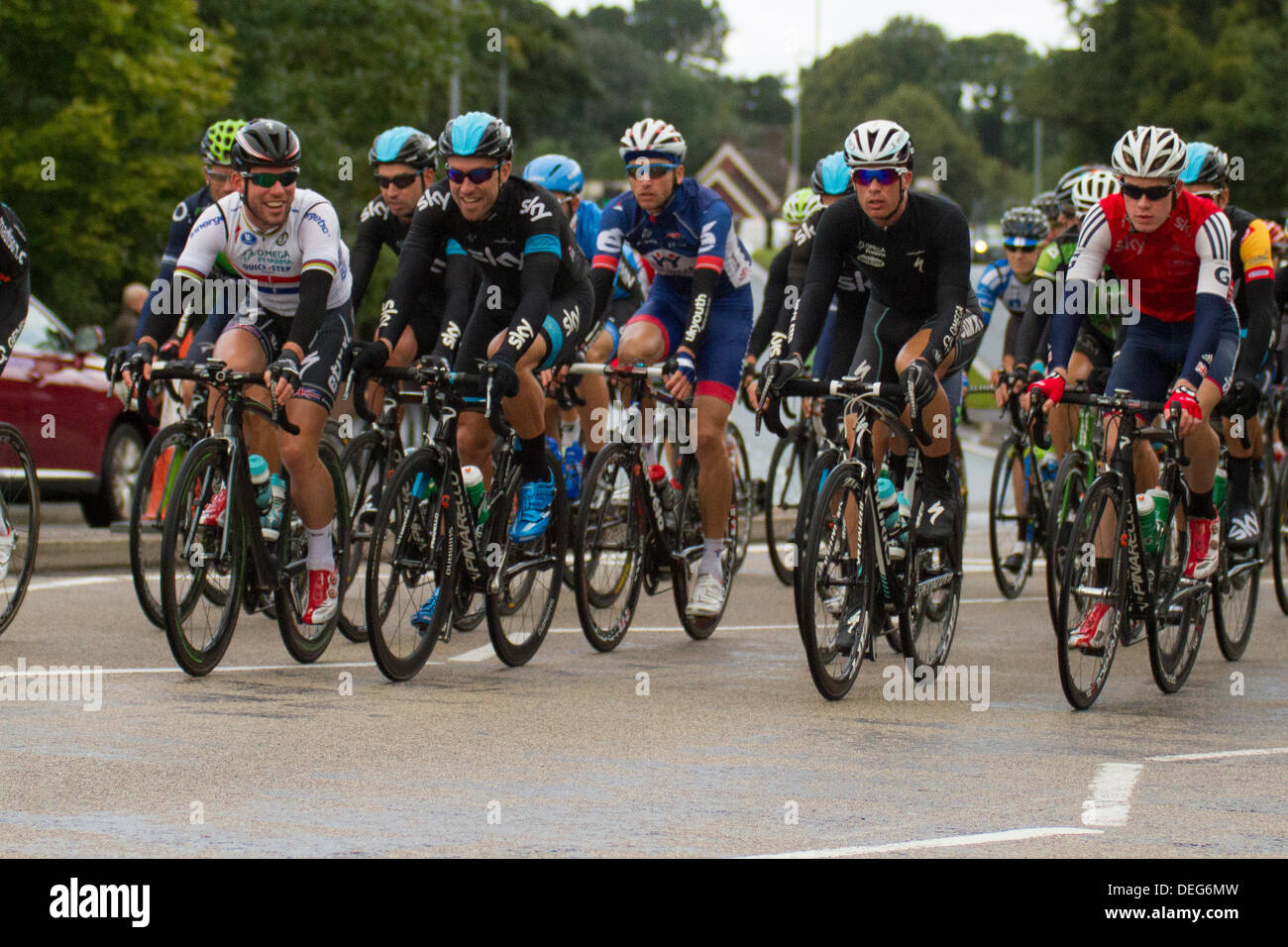 Stoke on Trent, Staffordshire, UK. 18th Sep, 2013. Mark Cavendish of Omega Pharma Quick-step shares a joke with Team Sky as they pass through the Trentham area of Stoke on Trent, Staffordshire on stage 4 of the Tour of Britain. Credit:  Alex Williams/Alamy Live News Stock Photo