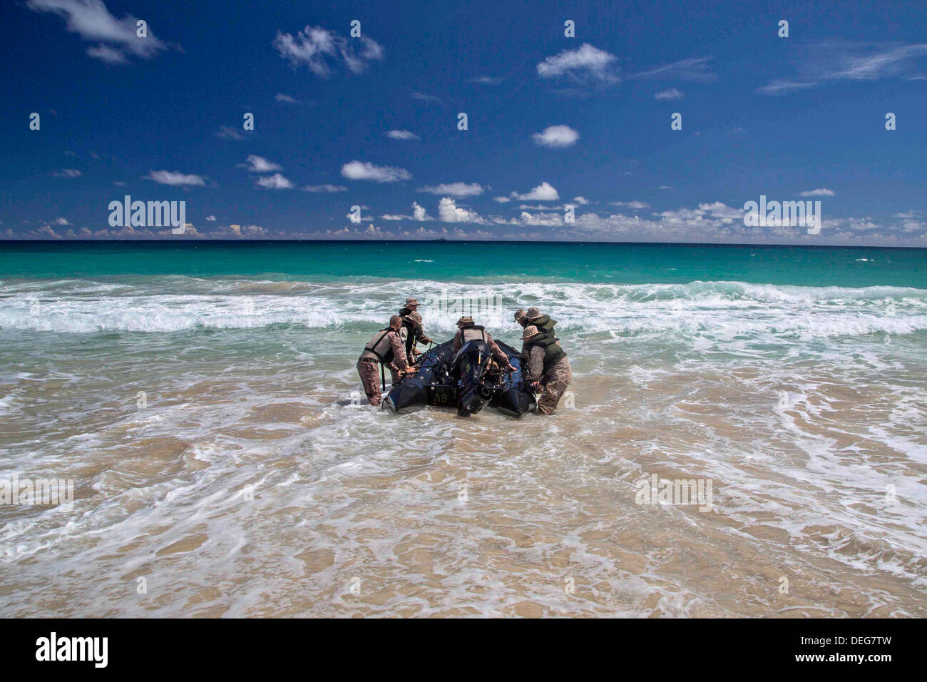 A US Marine Battalion Landing Team conduct training with a combat rubber reconnaissance craft on the beach August 30, 2013 in Hawaii. Stock Photo