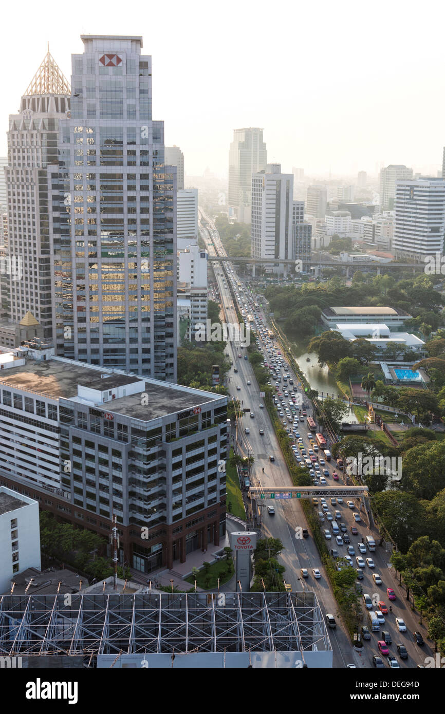 High rise buildings and traffic congestion on Rama IV in evening light, Sathorn Road, Bangkok, Thailand Stock Photo