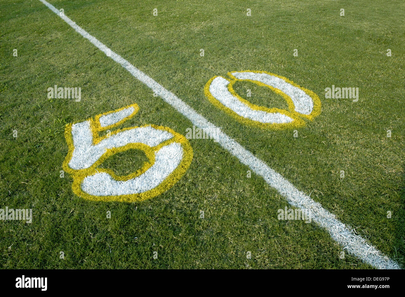Painted yardage lines of football field, some being painted Stock Photo