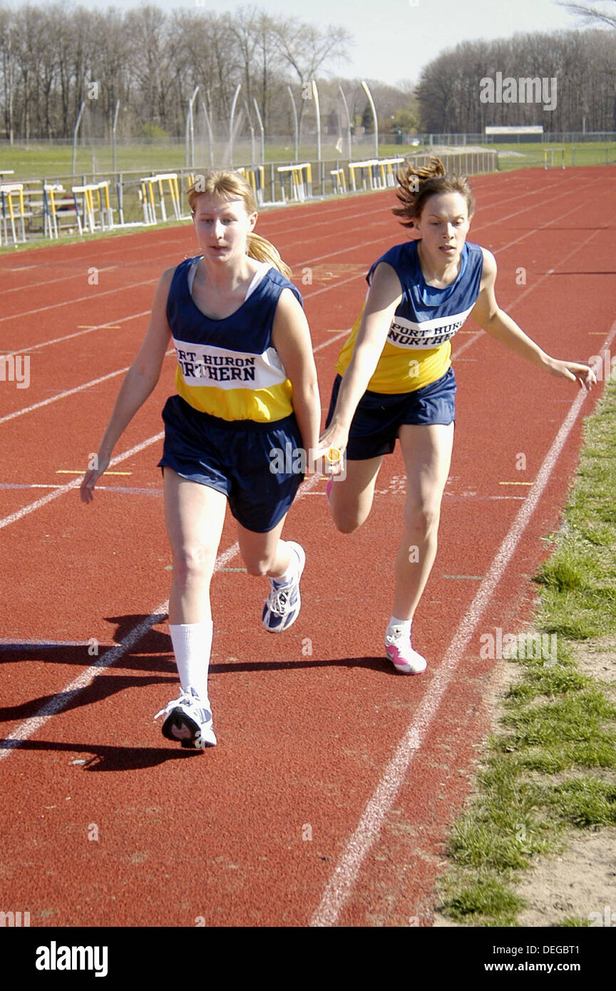 Relay race runners. High School track meet Stock Photo Alamy