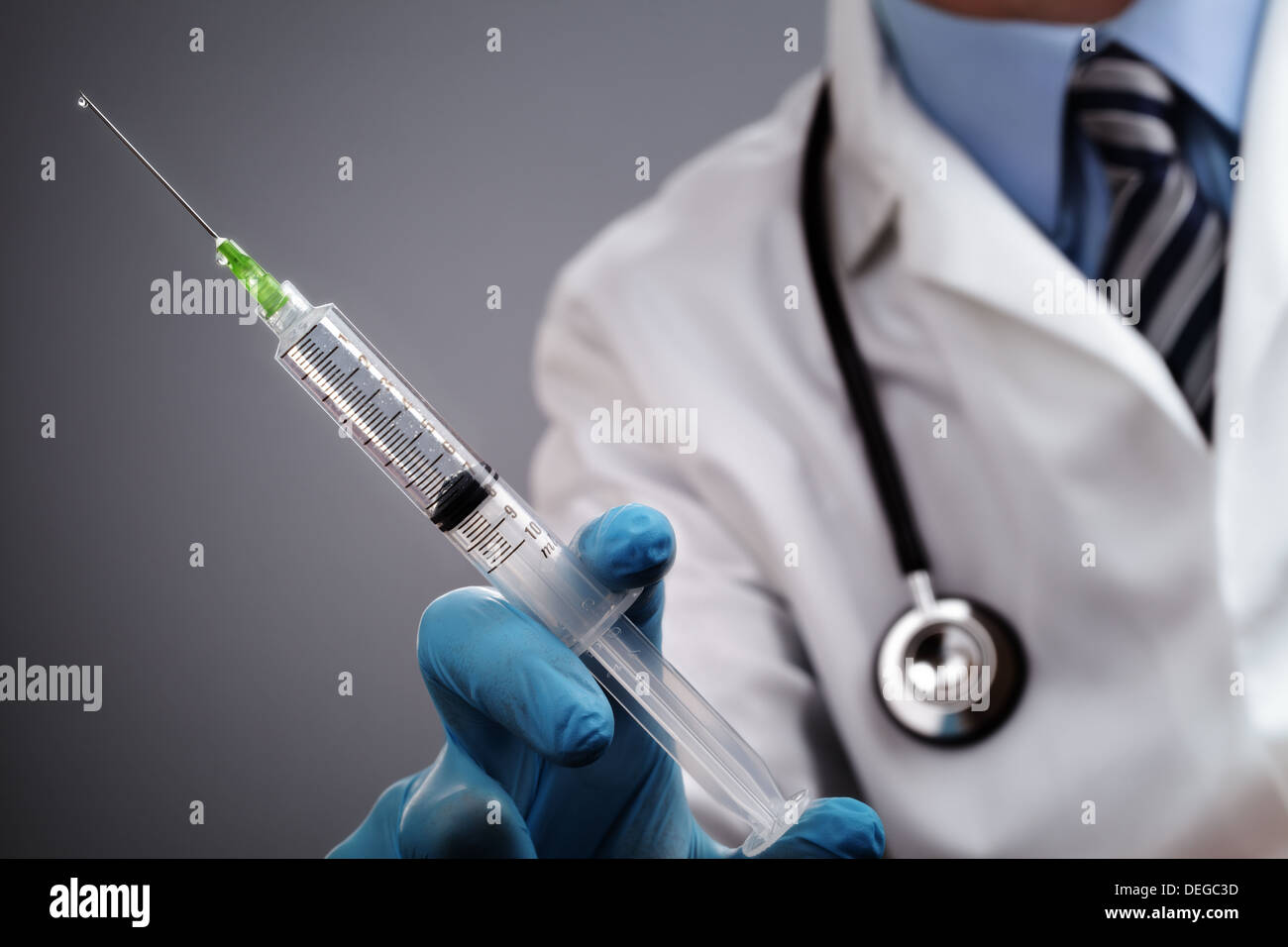 Doctor with syringe and stethoscope Stock Photo
