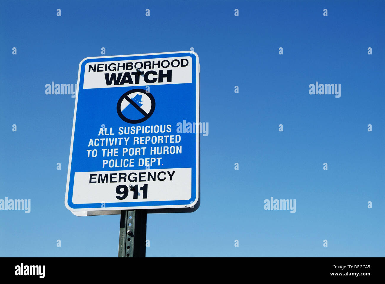 Neighborhood watch sign advises suspicious activity to be reported to