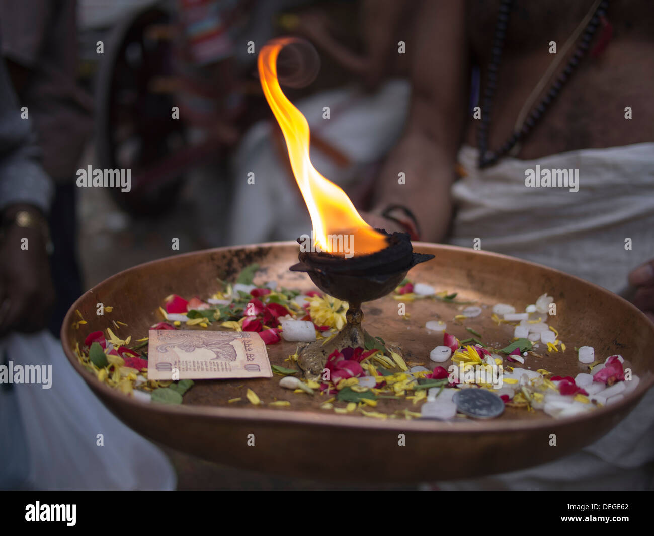A fire burns in a golden bowl in Bangalore, Karnataka, India. Stock Photo