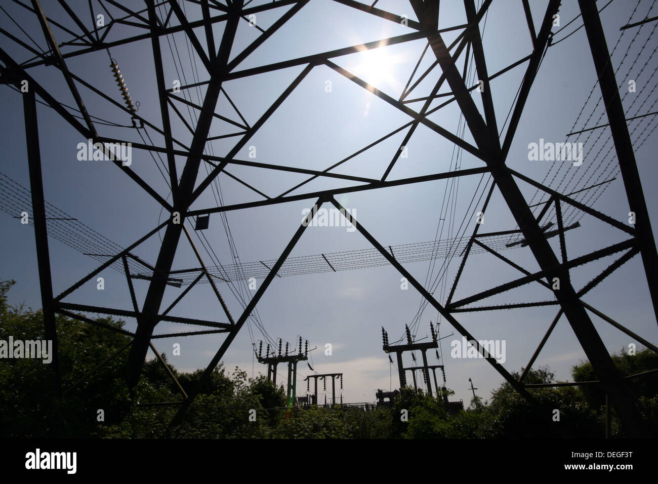 Electricity Pylons lit up by a summer sun. Stock Photo