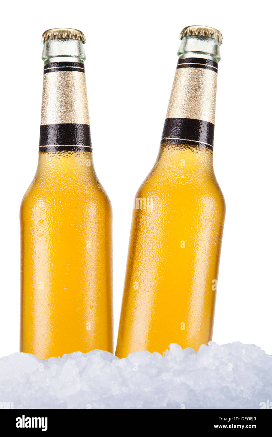 Two beer bottles sitting on ice over a white background. Stock Photo