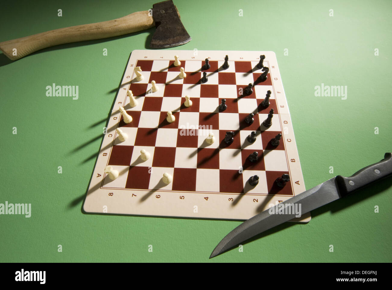 chessboard with knife and ax Stock Photo