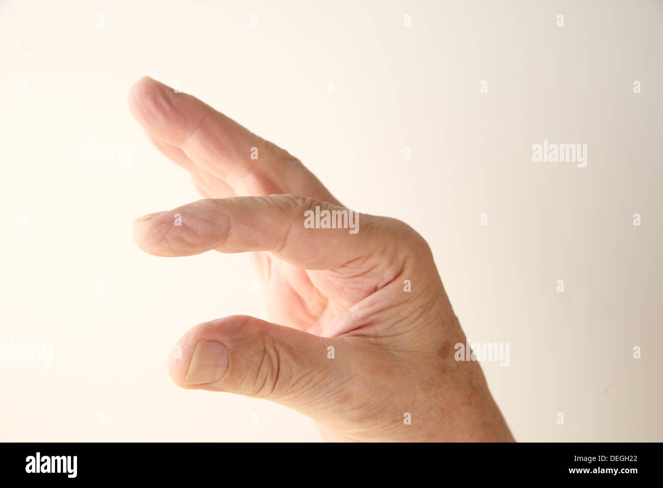 a man's hand indicating smallness or largeness Stock Photo