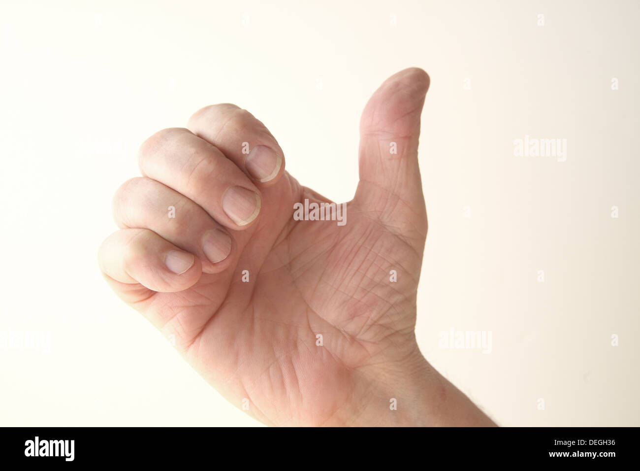 a man uses his hand in a gesture that has several meanings Stock Photo