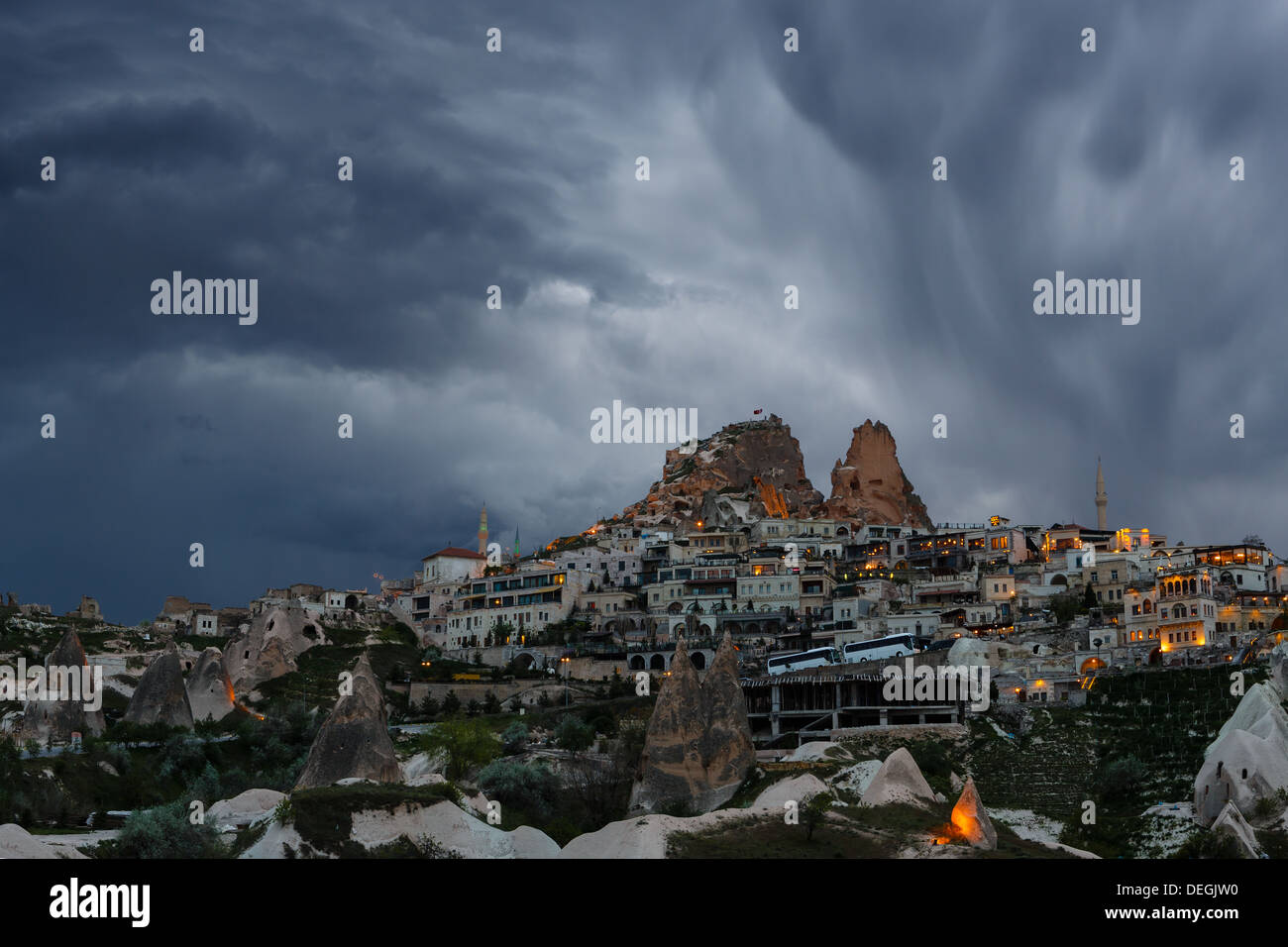 Cloudy twilight on the small town on a rock slope Stock Photo