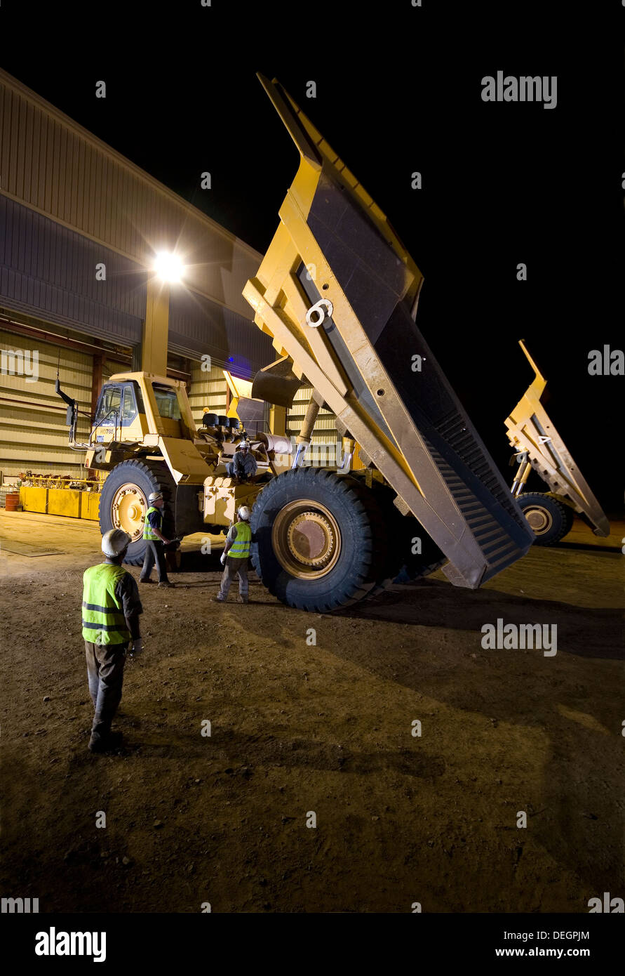 Night shot showing 24 hour working at vehicle maintenance workshop, goldmine haul trucks, Mauritania, NW Africa Stock Photo