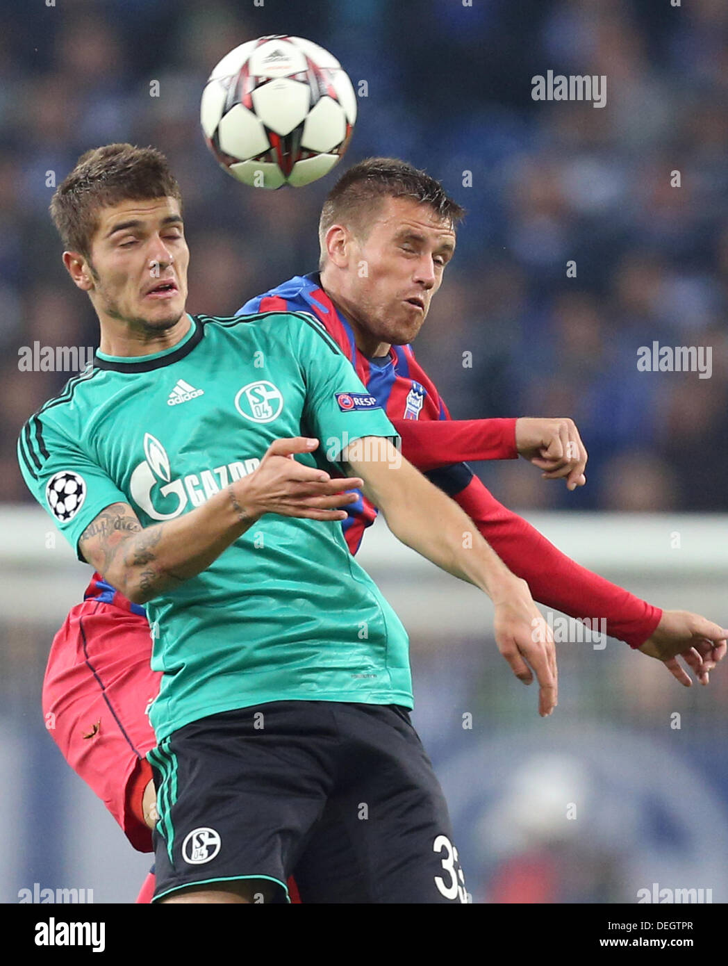 Stadion Gelsenkirchen, Gelsenkirchen, Germany. 18th Sep, 2013. Schalke's Roman Neustaedter (L) and Mihai Pintilii (R) of Bucharest vie for the ball during the UEFA Champions League group E soccer match between FC Schalke 04 and Steaua Bucharest at Stadion Gelsenkirchen, Gelsenkirchen, Germany, 18 September 2013. Photo: Friso Gentsch/dpa/Alamy Live News Credit:  dpa picture alliance/Alamy Live News Stock Photo