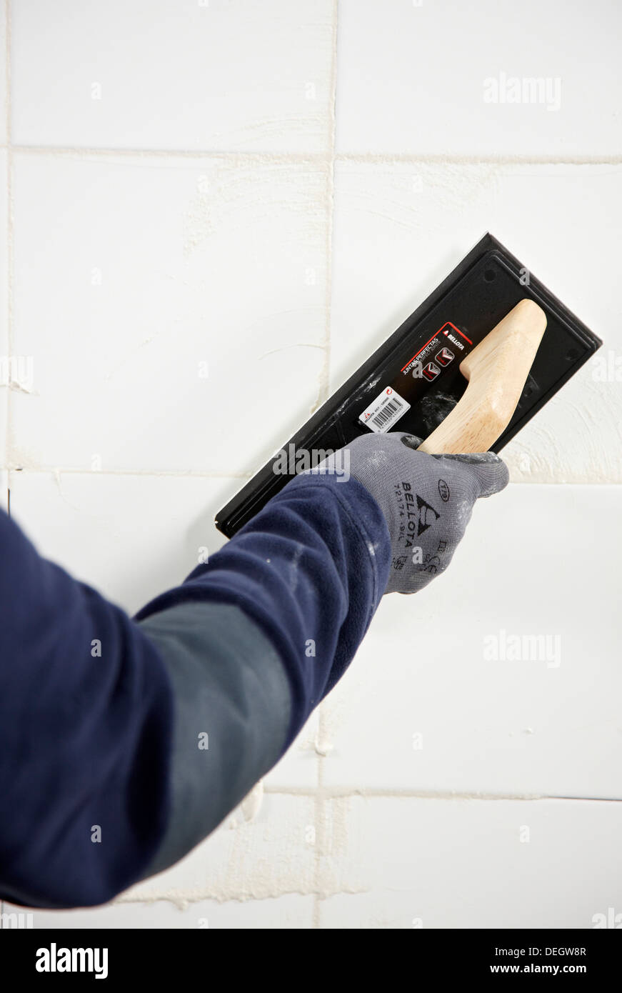 Laying tiles, glue mortar, using grout float, new homes under