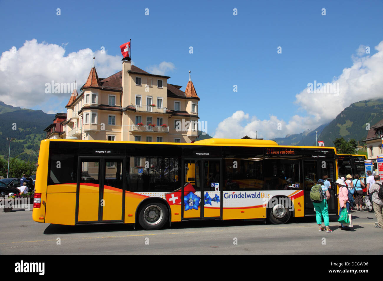 Yellow Swiss Postbus in Grindelwald, Switzerland. Stock Photo