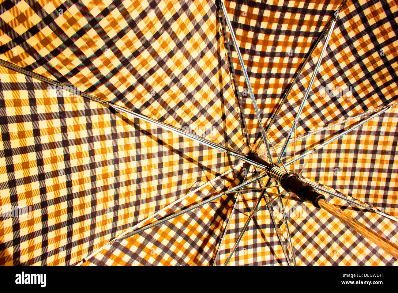 Abstract closeup of opened square retro patterned umbrella and handle Stock Photo