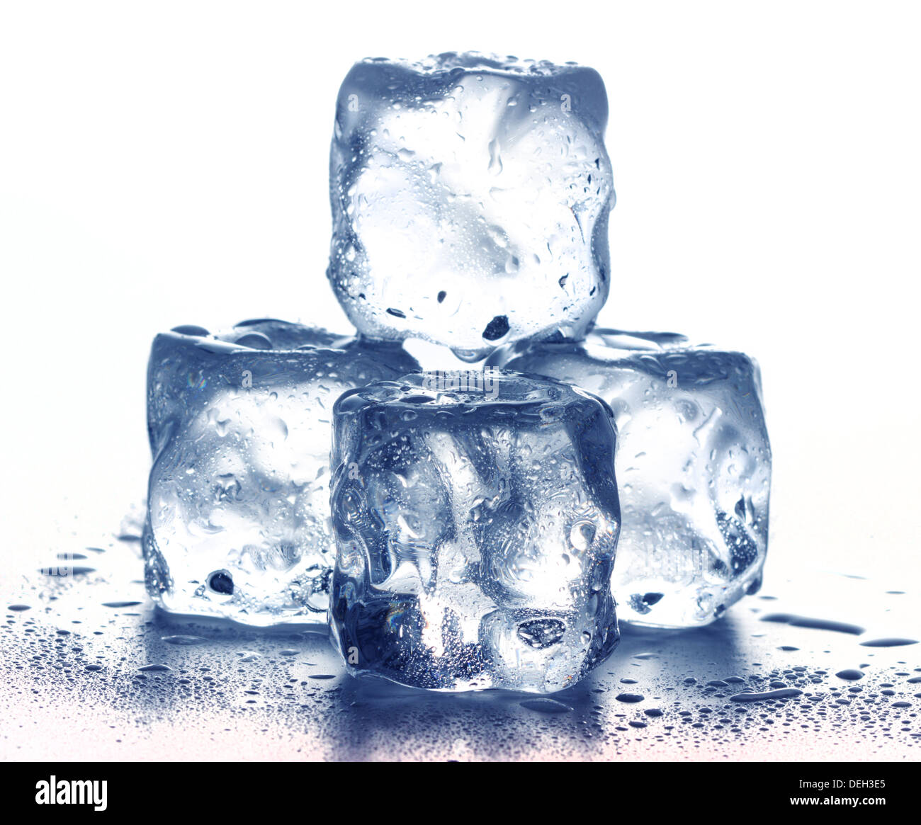 Melting frozen ice cubes illuminated with blue coloured LED light in the  dark Stock Photo - Alamy