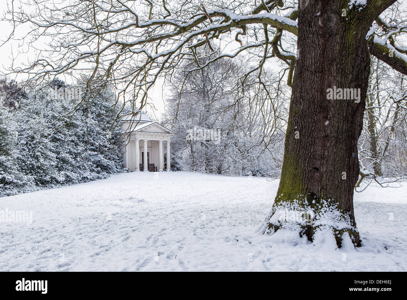 The Temple of Bellona by Sir William Chambers (1760) is surrounded by snow covered trees and shrubs in Winter - Kew Gardens,Greater London,UK Stock Photo