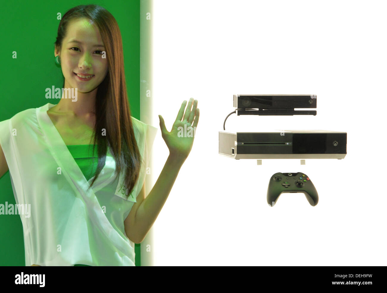 Tokyo, Japan - A companion shows off Xbox One in the Microsoft booth at the  Makuhari Messe convention center on the opening day of the Tokyo Game Show,  one of the world's