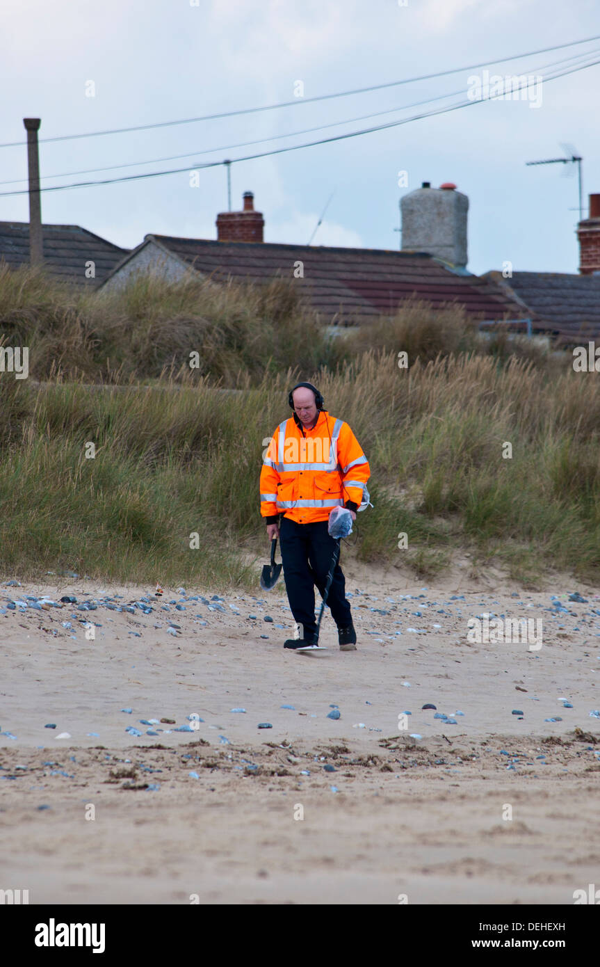 Man on beach with metal detector Stock Photo - Alamy