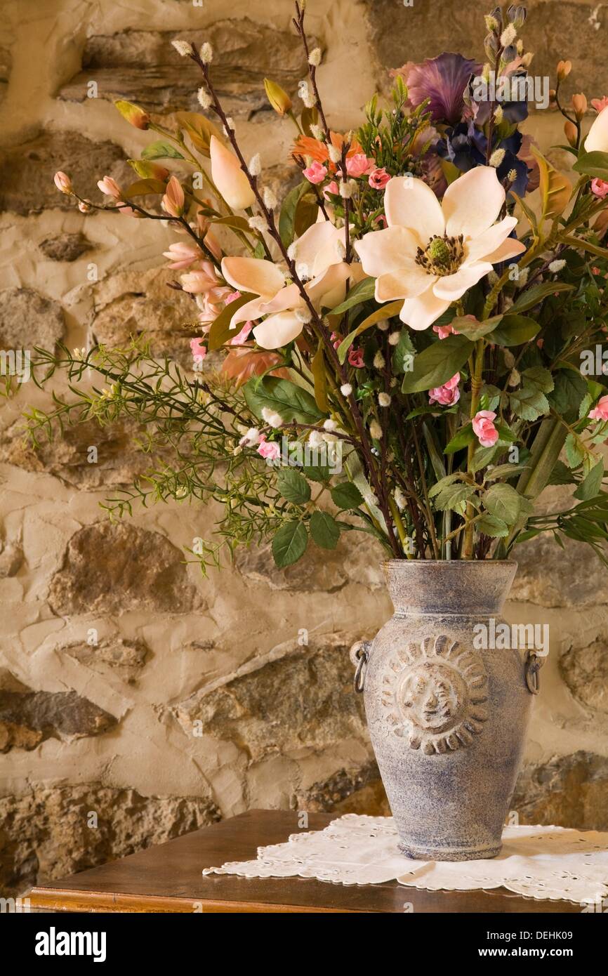 Close Up Of A Ceramic Flower Vase With Silk Flowers On A Night