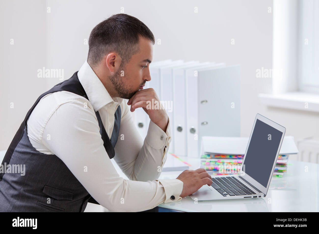 Young businessman using laptop desk Stock Photo