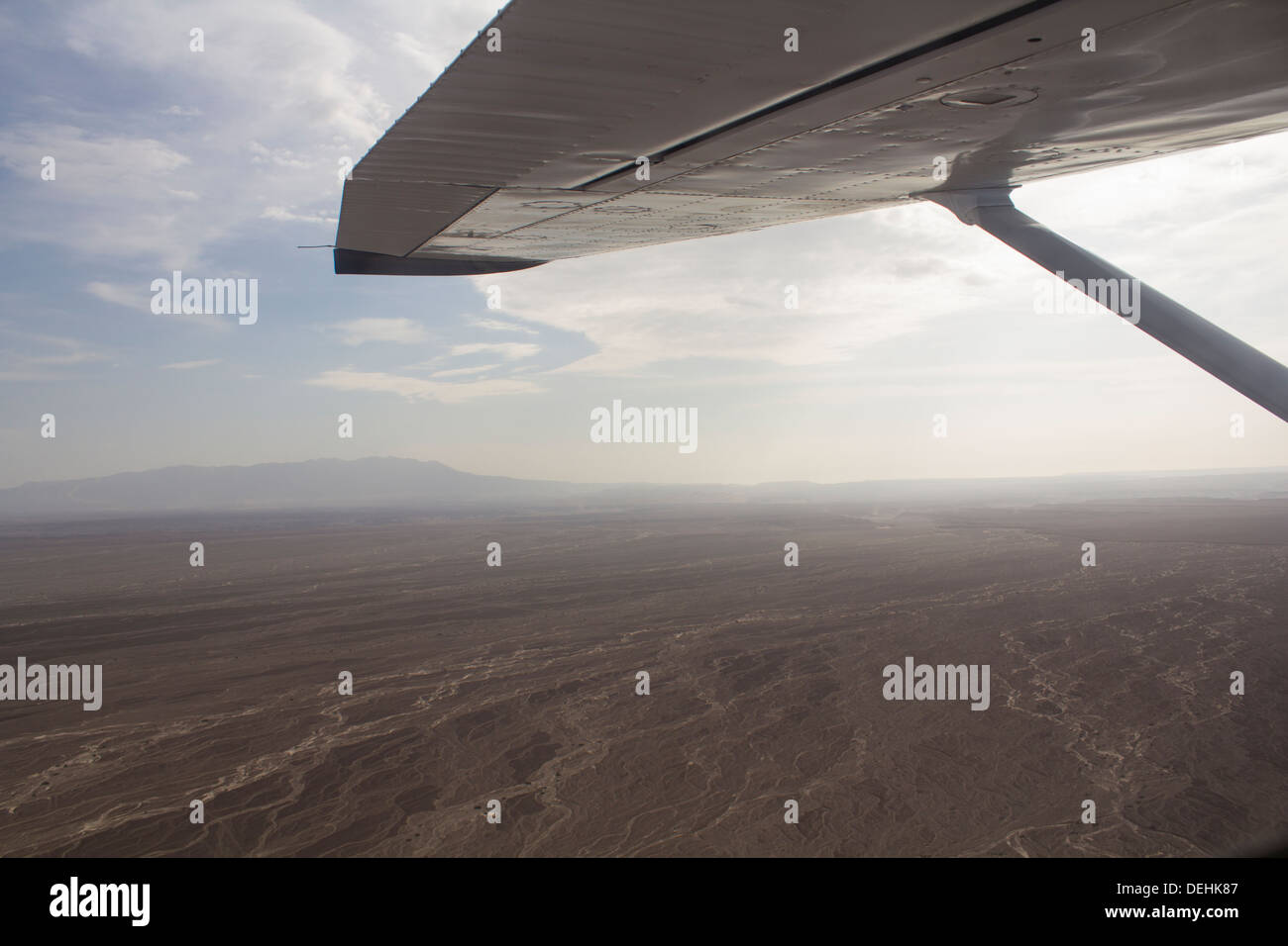 Wing-tip view of Nazca lines and desert, Peru Stock Photo