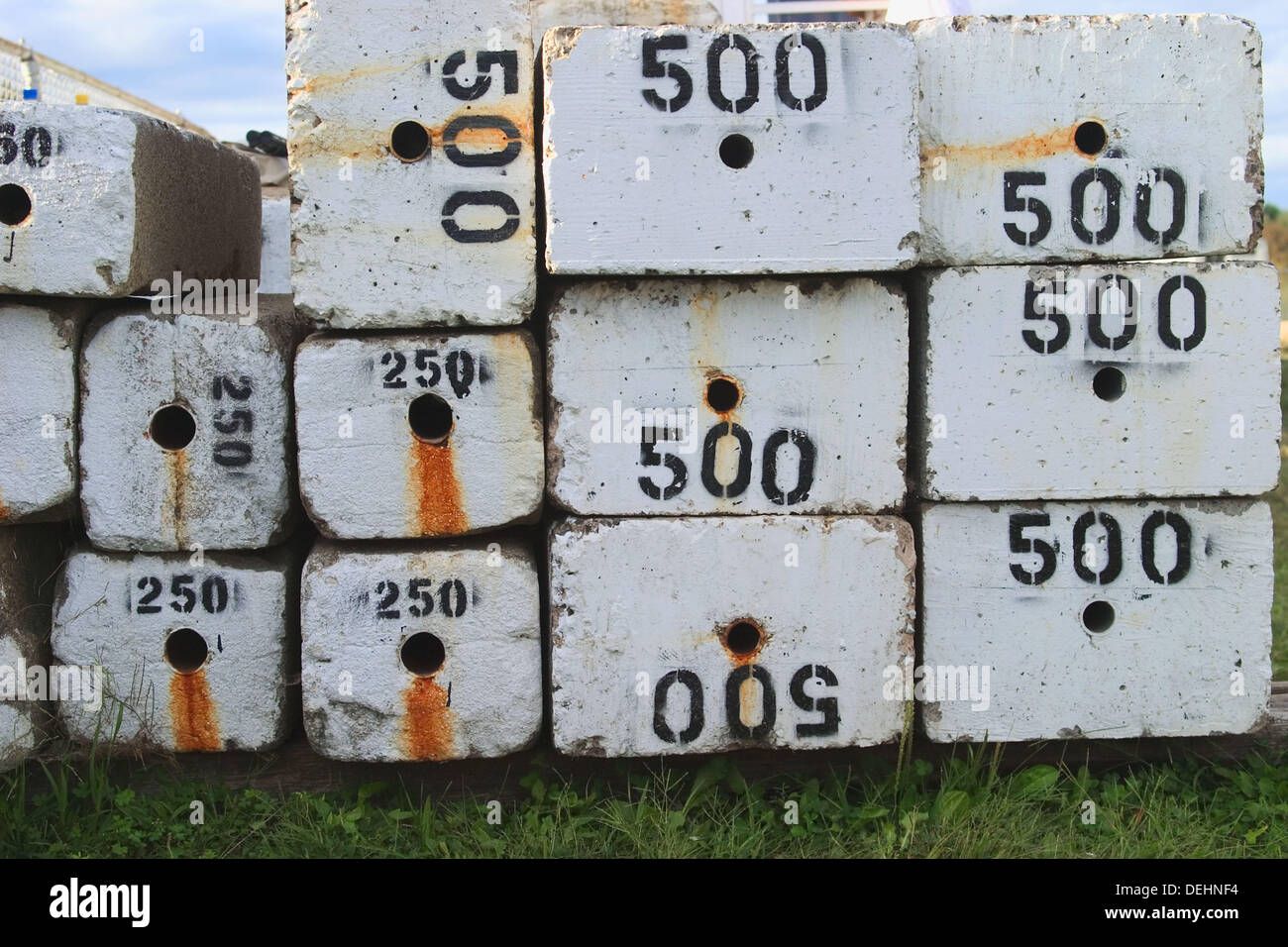 Heavy concrete blocks, with their weights printed on them, piled