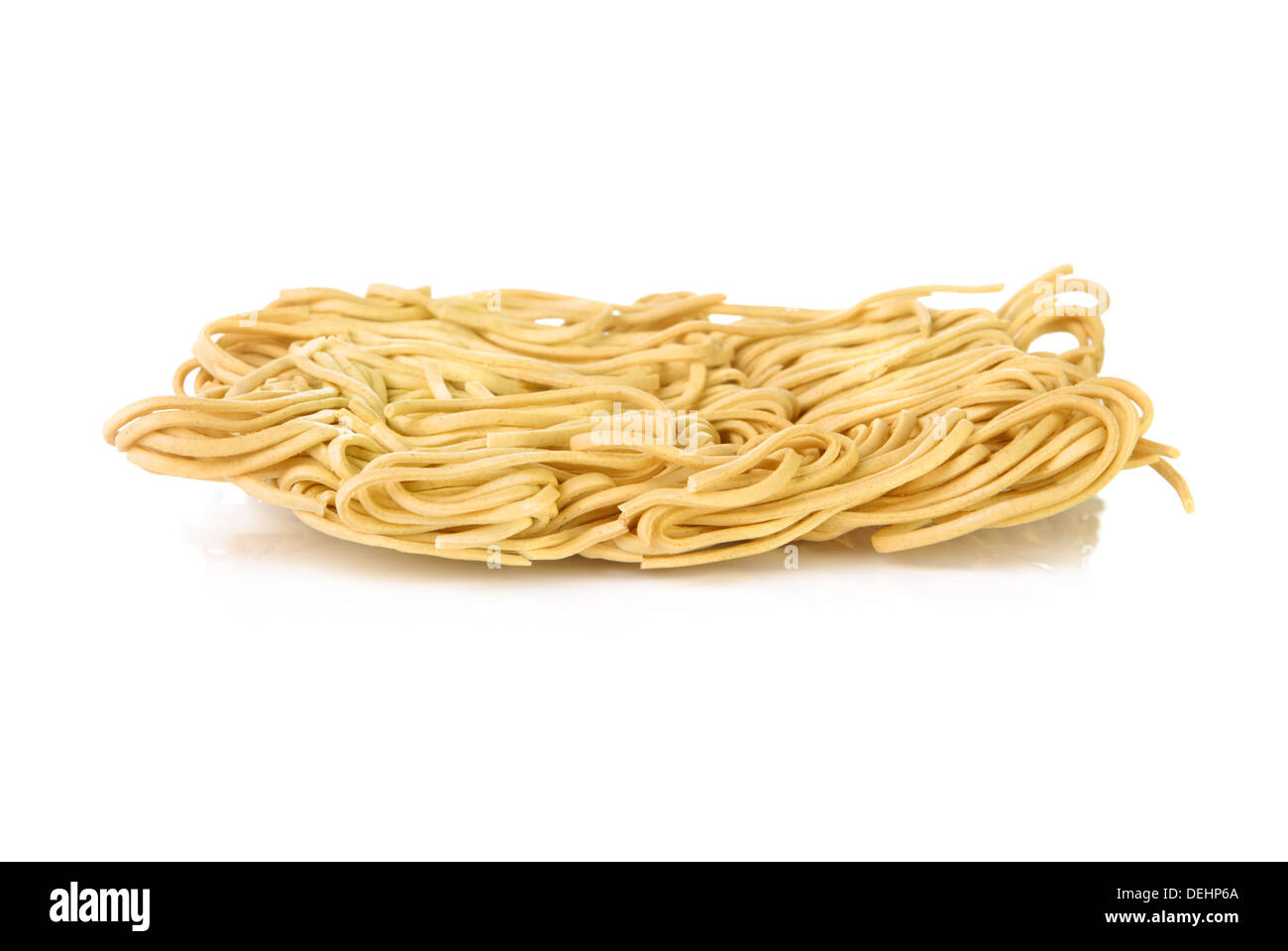 Dry egg noodles over a white background Stock Photo