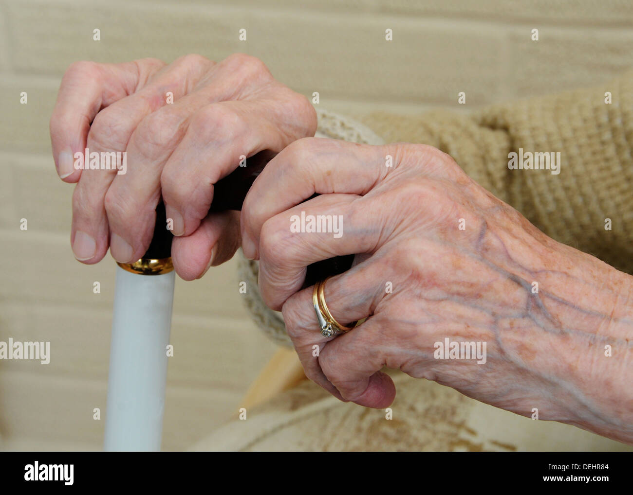 Old Senior lady lady's hands pensioner with walking stick Stock Photo