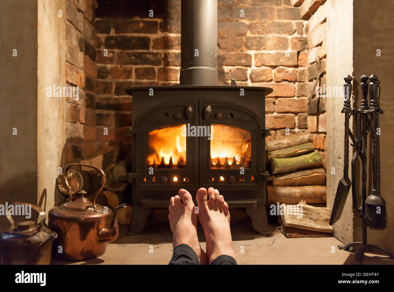 After a freezing cold Winter's walk, two feet thaw out in the warmth of a roaring fire being