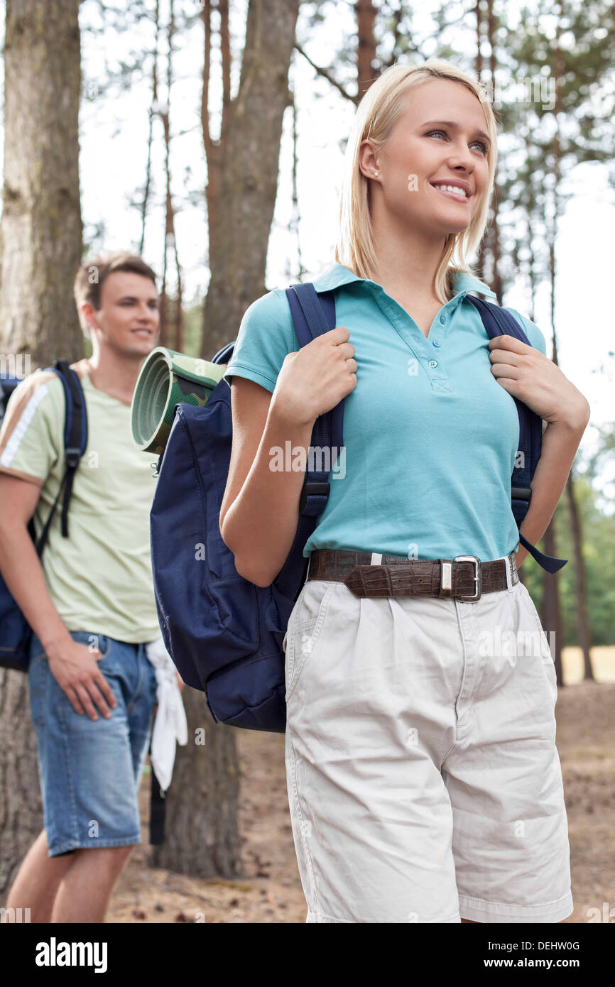Happy young woman with man hiking forest Stock Photo