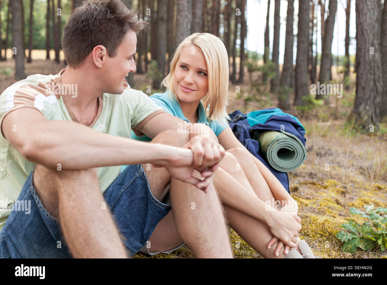 Hiking couple looking each other while relaxing forest Stock Photo