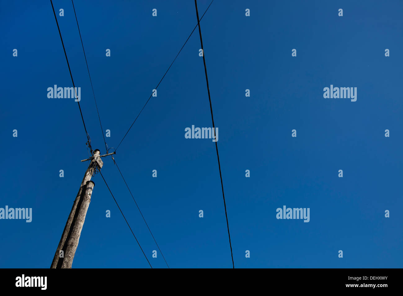Low angle view electric wires against clear blue sky Stock Photo