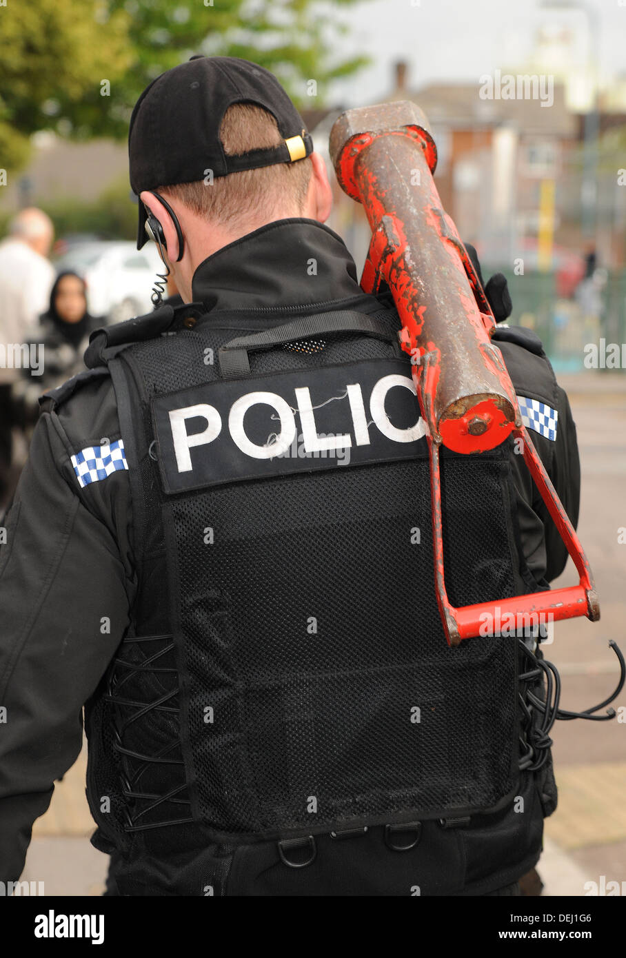 A British police SWAT team member following a house entry. REAL POLICE INCIDENT Stock Photo