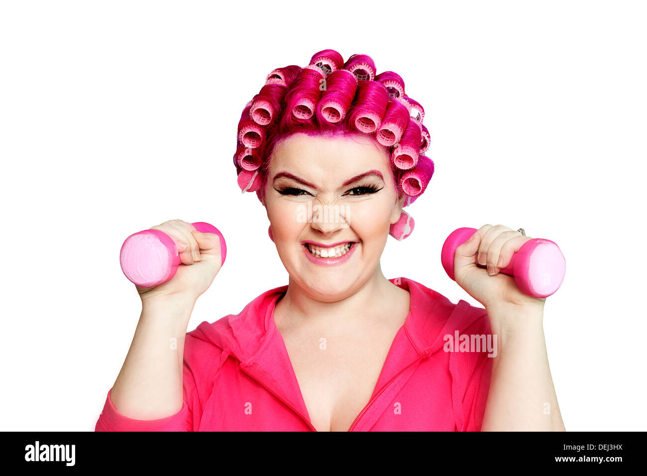 Portrait a young woman happily lifting weights Stock Photo