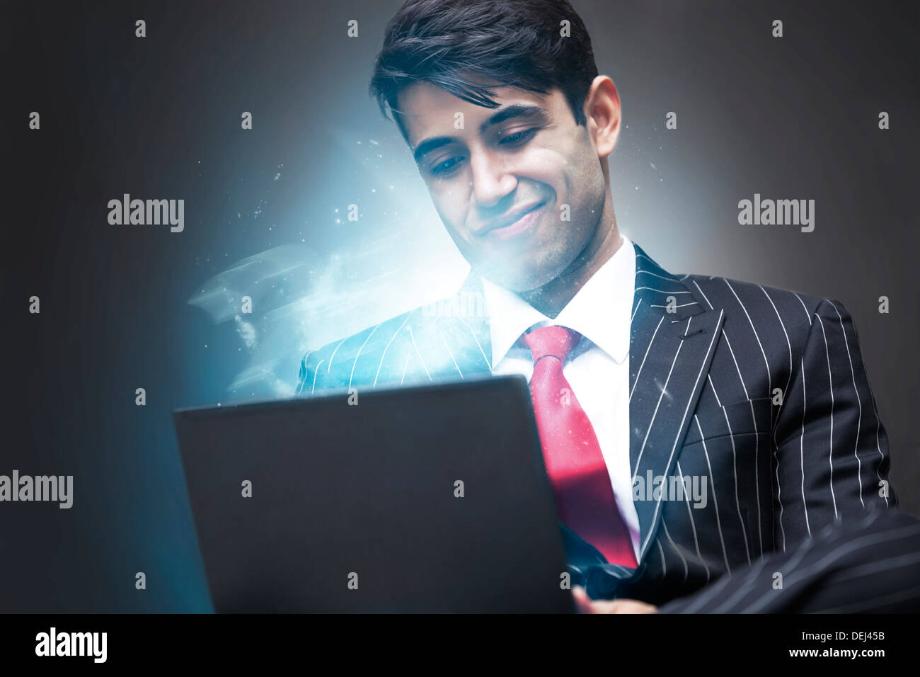 Young Indian Business Man using illuminated tablet Stock Photo