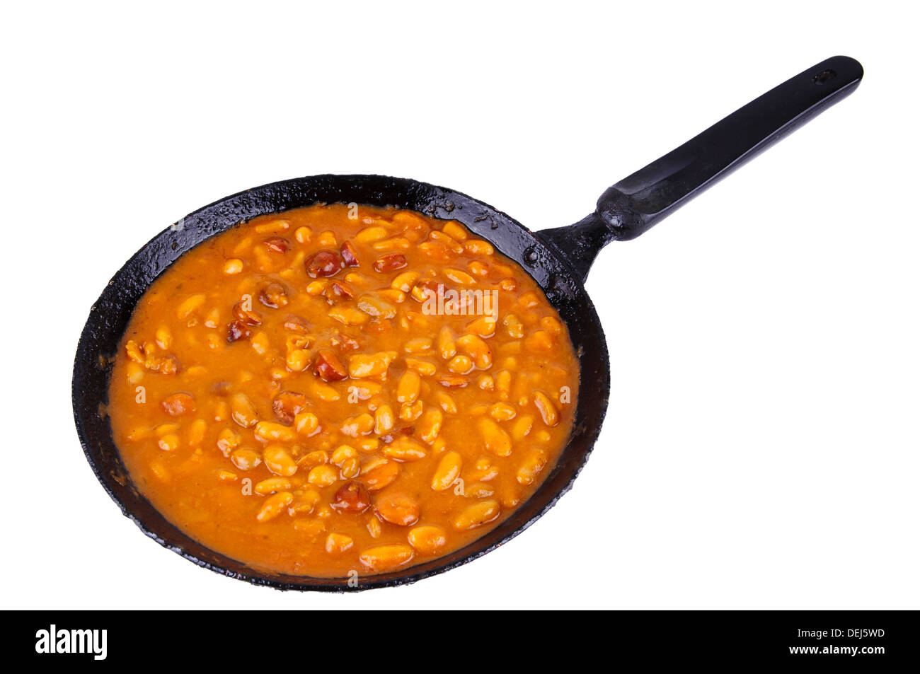 traditional homemade meal with beans and sausages in a pan isolated on a white background Stock Photo