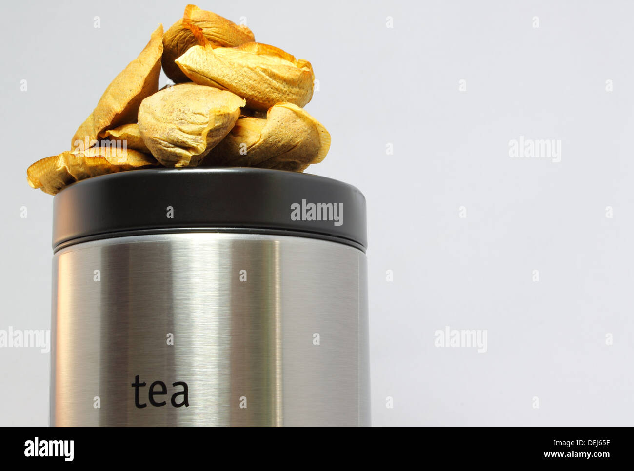 Conceptual image showing recycled teabags for composting on a silver