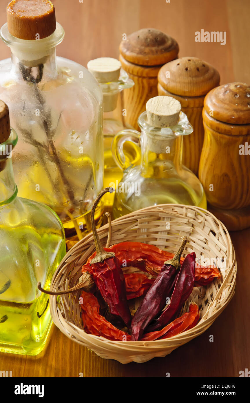 dried chili with olive oil and condiments on a wooden background Stock Photo