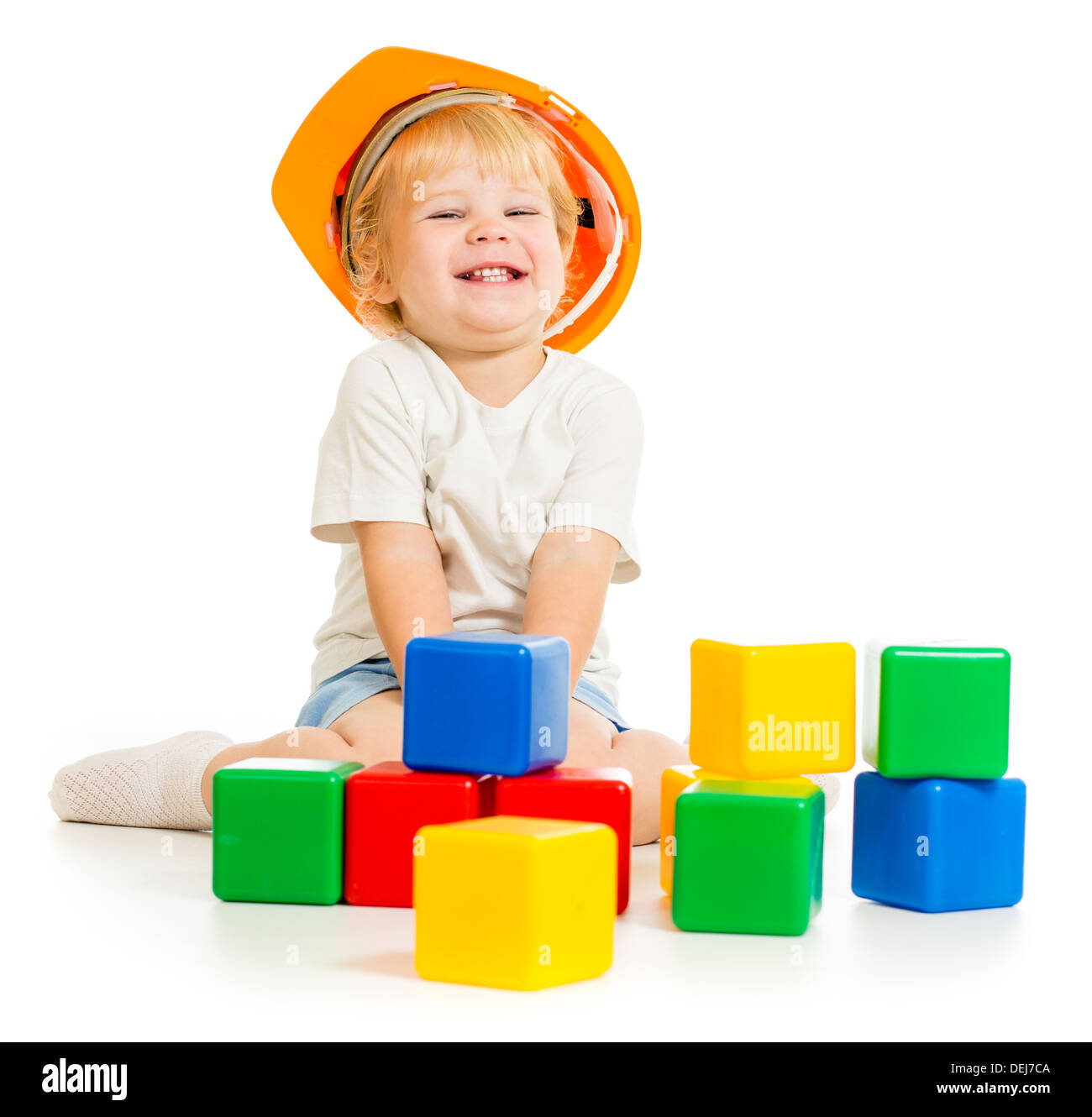 baby boy in hard hat with colorful building blocks Stock Photo