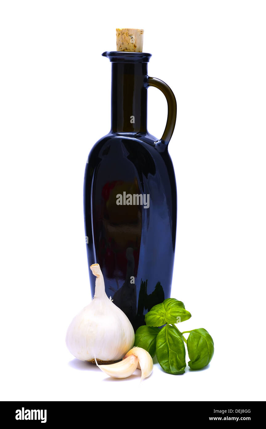 bottle of vinegar with garlic and basil isolated on a white background Stock Photo