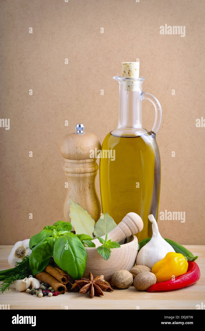 still life with herbs, spices and olive oil on a wooden background Stock Photo
