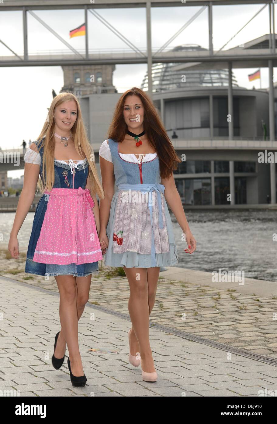 Janine L and Sophie present dirndl dresses made from worn out jeans at the Spree in Berlin Germany 19 September 2013. The students of the school for fashion and design Magedburg created the