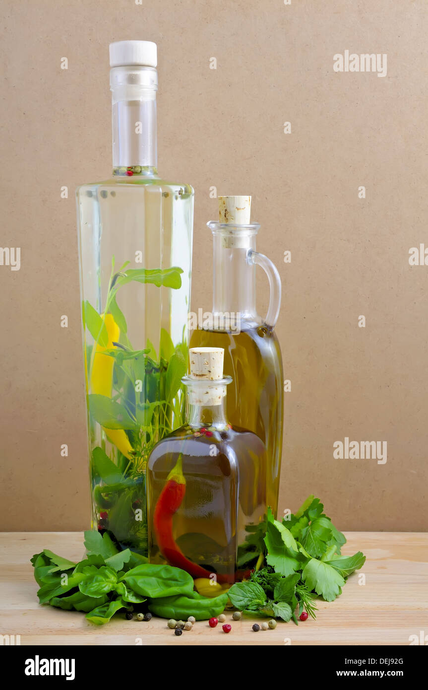 olive and herbal oil with fresh green herbs Stock Photo