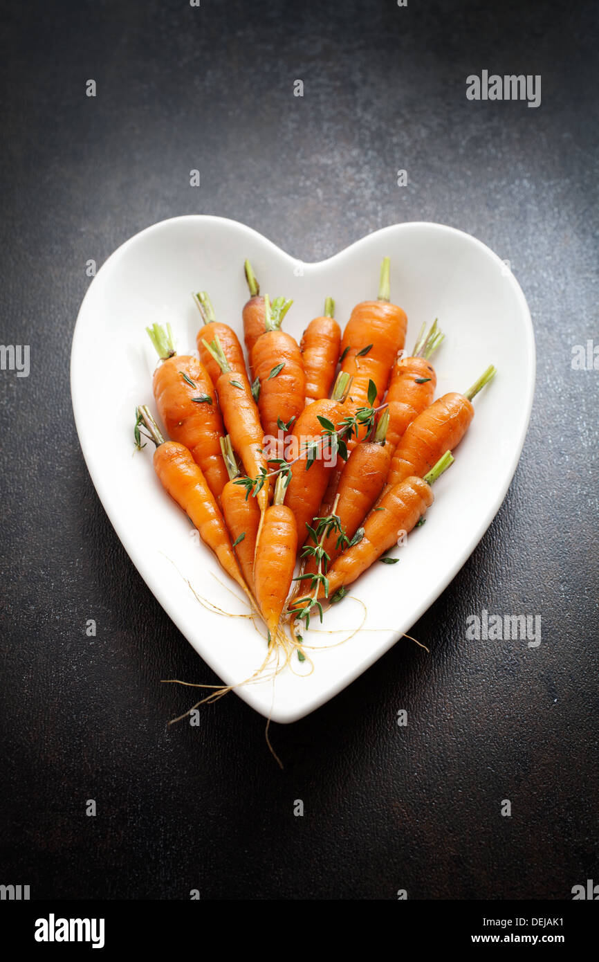 Close up of carrots with fresh thyme  Stock Photo