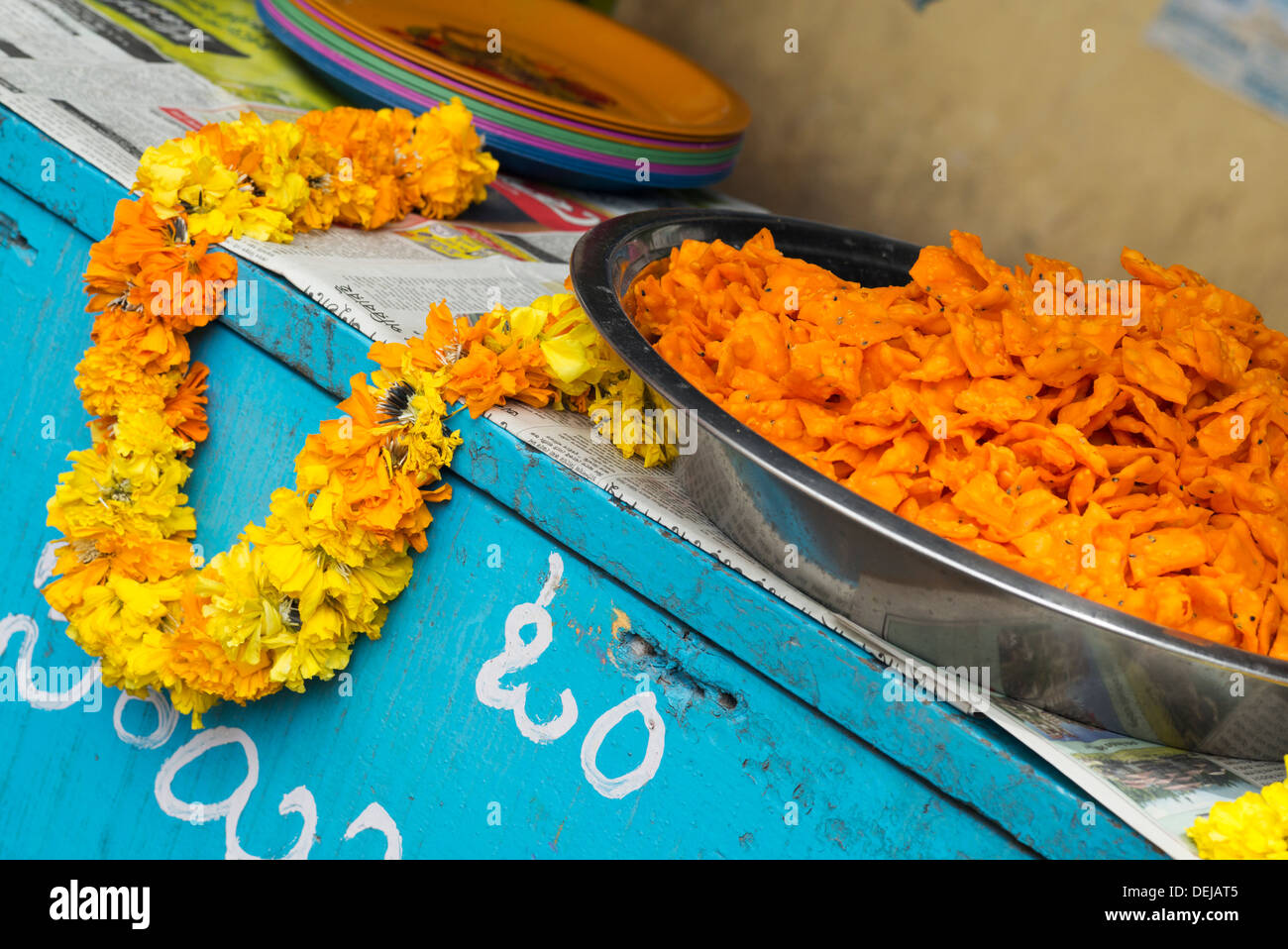 Deep fried indian street food and flower garland. India Stock Photo